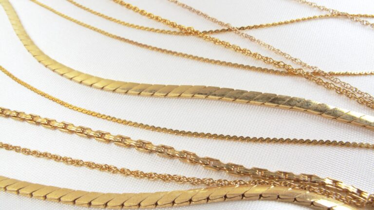 an image of various yellow gold chains laying on a table to show comparison of each other