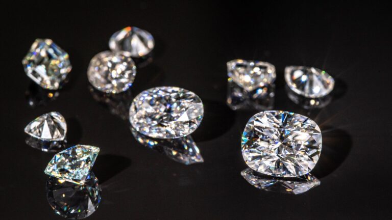 a picture of various natural and lab-grown diamonds with a black background