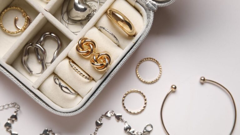 an overhead image looking down at a jewelry box with various jewelry pieces in yellow and white gold that are timeless pieces