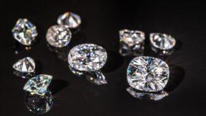 a black background with numerous natural and lab grown diamonds of various sizes resting